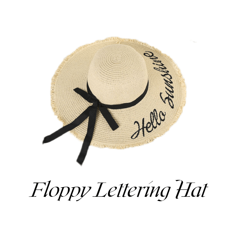 A light color floppy lettering hat with a black ribbon reads hello sunshine.