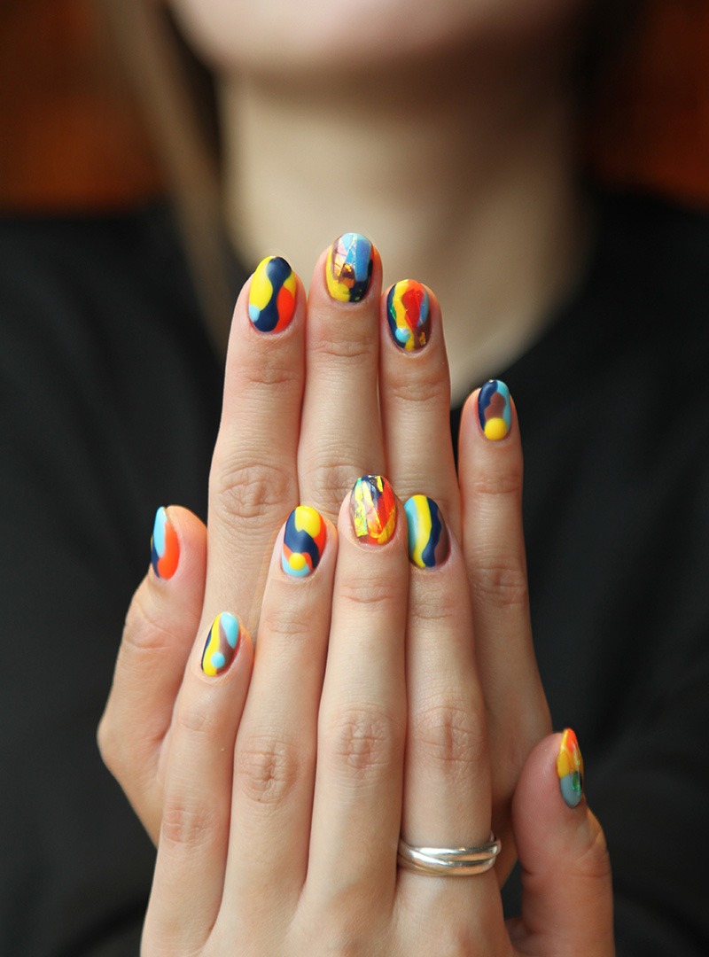 Woman's Hands with polished nails of random colors