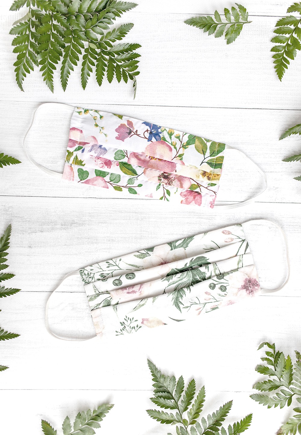 Floral patterned face masks surrounded by plants.