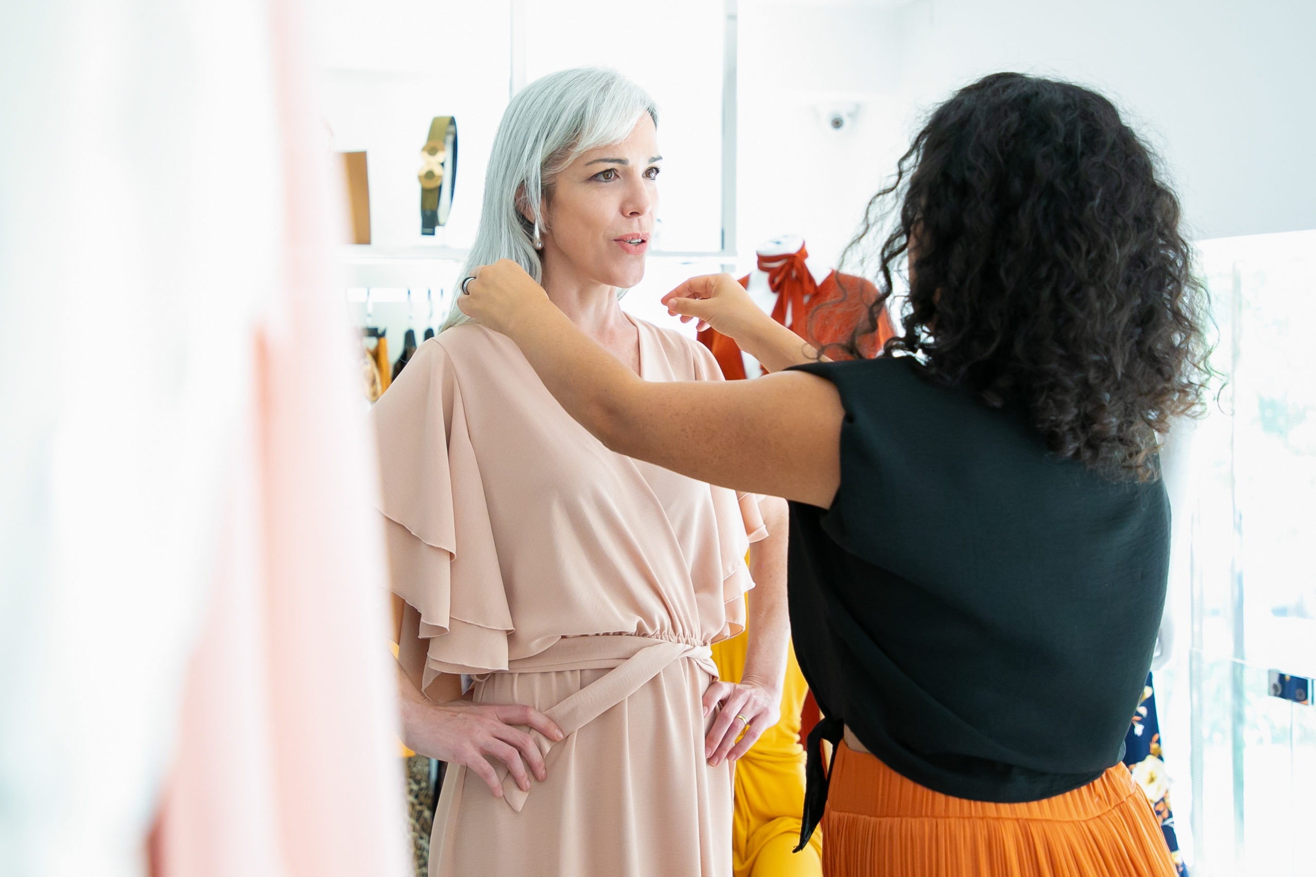 Woman's hands with polished nails in cyan color offering a seashell